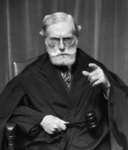 1930s Stern Elderly Judge With Beard And Glasses Pointing At Camera